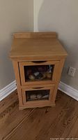 Front view of light oak veneer potato/onion bin with two mesh panel drawers
