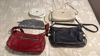 Top view of all five handbags laid flat