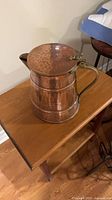 Full view of hammered copper pot with lid and brass/bronze bail handle