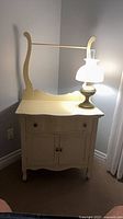 Front view of cream painted vanity with mirror frame and lamp (lamp not included)