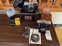 Group shot of entire lot showing cameras, bags, accessories