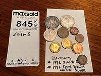 Group shot of all German coins on card, shows two 5-Mark pieces and six smaller denomination coins