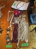 All six necklaces laid out on table