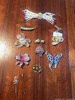 All 13 costume jewelry pieces laid out on wood surface