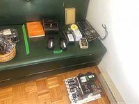 Group shot showing all electronic testers, boards, book and connectors on bench and floor