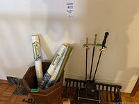 overall lot showing planter with wallpaper rolls, metal wall plates, log holder and fireplace tool set