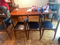 Four chairs lined up showing overall design and condition