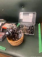 basket with many sunglasses and plastic tub of reading glasses