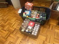 Laundry basket and box filled with packaged light bulbs