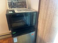 Front view of Panasonic microwave atop a mini-fridge (fridge not included)