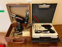 Both Weller D550 soldering gun kits open showing contents
