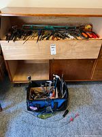 Overall view of tool bag on floor and drawer with various tools
