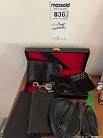 Group shot of all seven black leather accessories