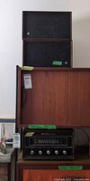 Radio receiver and stacked speakers on cabinet