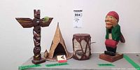 All four items together: totem pole, teepee, drum, nutcracker