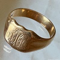 Front view showing engraved initials on signet face and side contour