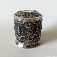 Full view of betel nut box showing repousse figures and lid