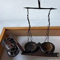 Scale suspended from cords showing brass pans