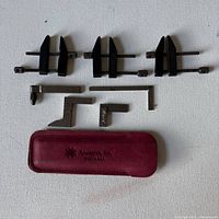 Overall view of clamps, squares, gauge accessories and Spyderco case