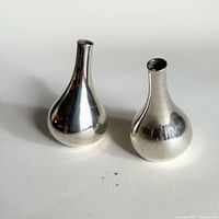 Pair of silver-plated teardrop candle holders front view
