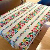 Tablecloth laid on dining table showing full pattern and size