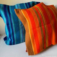 Both striped pillow covers standing together showing colors and weave