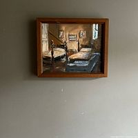 Front view of framed oil painting on wall