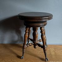 Full view of piano stool showing legs and feet