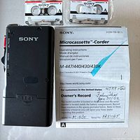 Rear view of Sony M-430 recorder with manual and owner’s record