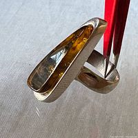 Ring angled to show amber cabochon in silver setting