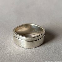 Angled view of sterling silver soft square band showing outer groove