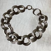Full view of bracelet laid flat showing interlocking multi-ring links