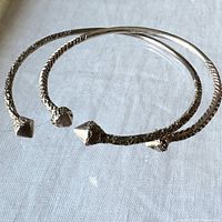 Both sterling silver cuff bracelets side by side showing texture and pyramid ends