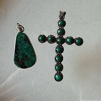Front view of both pendants showing malachite stones and silver settings