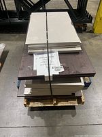 Pallet with stacked espresso and white laminate boards, label ST246766 visible