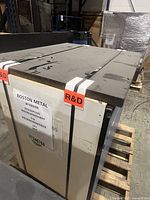 Grey‐topped plastic lab bench strapped on pallet