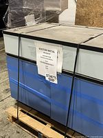 Front view of metal lab bench on pallet with label ST246775 visible