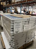 Shrink-wrapped pallet of blue-tone pod connector panels with Boston Metal label