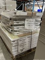 Shrink-wrapped pallet containing stacked Boston Metal office divider panels with labels visible