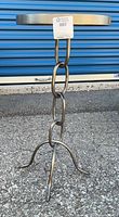 Full view of accent table showing chain-link base and tripod legs