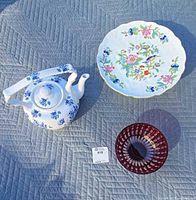 Group shot of teapot, cake plate and red bowl
