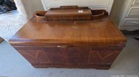 Front and top view of cedar chest showing overall design and wear
