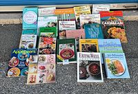 Full group of 21 assorted cookbooks laid out on pavement