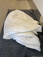 Folded white duvet on blanket