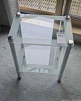 Front perspective showing two glass tiers and chrome legs