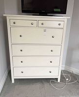 Front view of the white six-drawer dresser