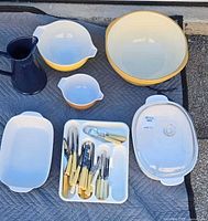 All items laid out: Corningware dishes, Gripstand bowl, Pyrex bowls, pitcher and cutlery tray