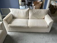 Front view of white IKEA loveseat showing overall design and condition