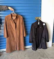Front view of both coats hanging