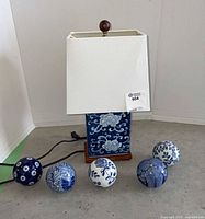 Full lot view showing lamp and five ceramic spheres